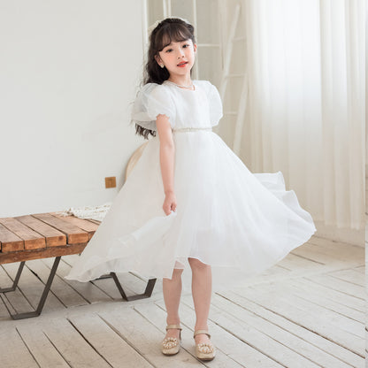 Girl in white flowing dress with ruffled sleeves