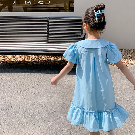kid girl in light blue dress with ruffled hem
