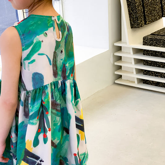kid girl in colorful sleeveless dress with abstract print