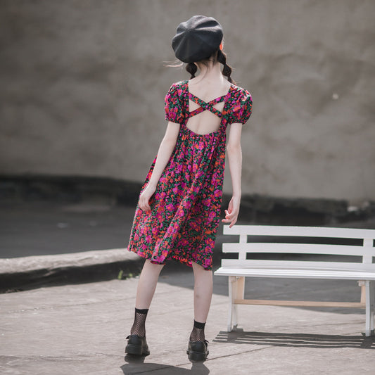 Child in a floral dress with a cut-out back