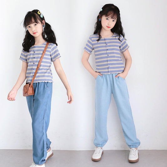 young girl wearing blue striped tee with denim pant