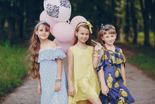 Young children wearing stylish clothing, representing the premier online destination for children's clothing in Singapore.