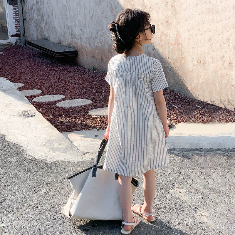 kid girl in a white and black striped dress wearing sandals