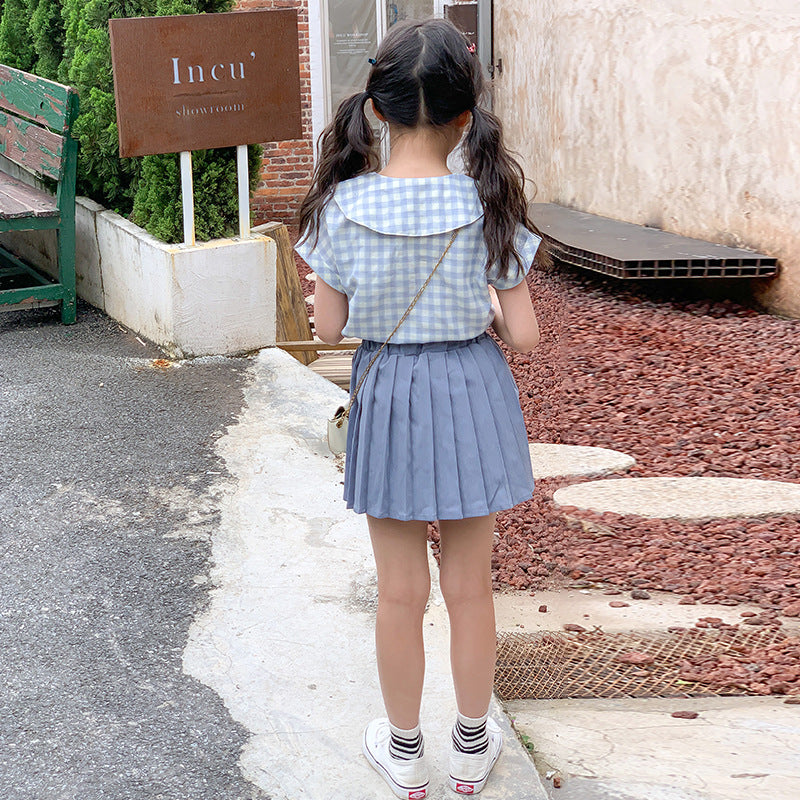 child fashion in a checkered top and blue skirt
