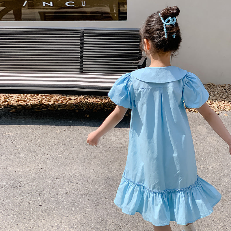 kid girl in light blue dress with ruffled hem