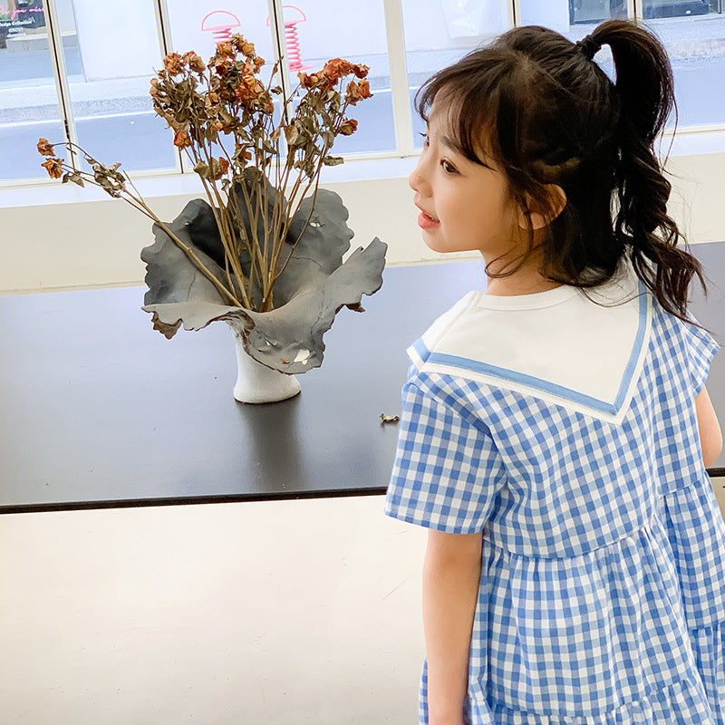 kid girl in blue checkered dress
