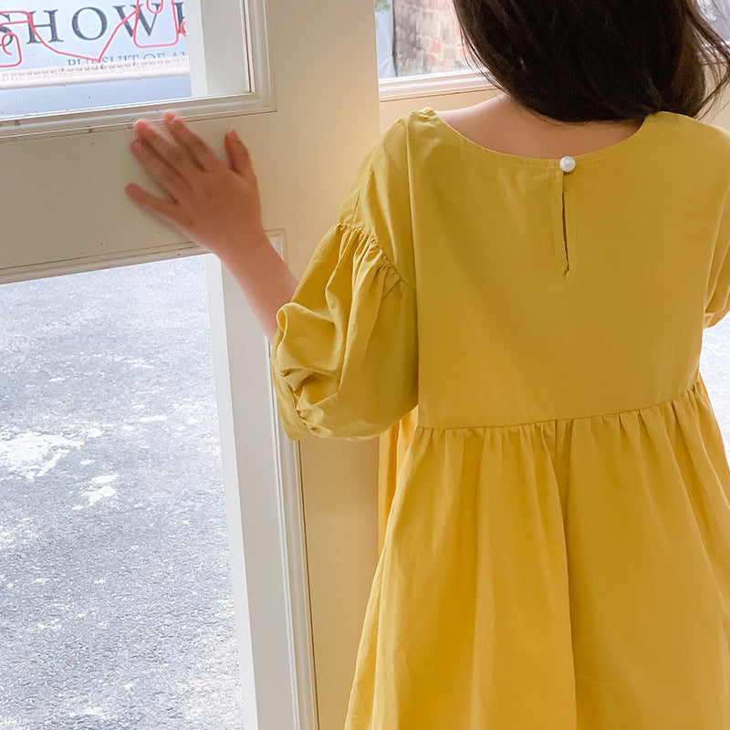 Kids in yellow dress with ruffled sleeves