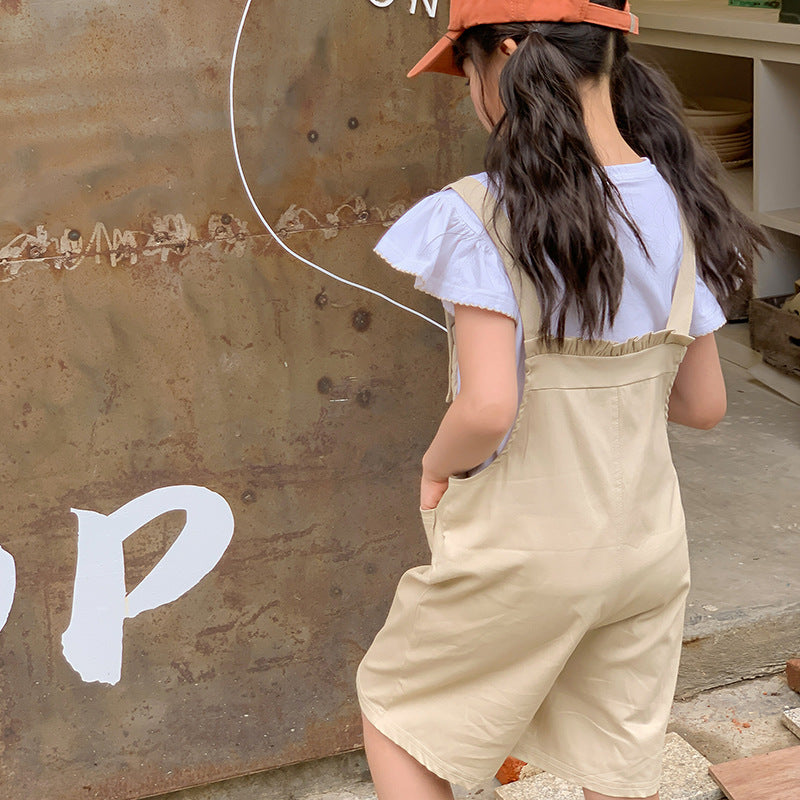 kids in beige one piece romper and white top