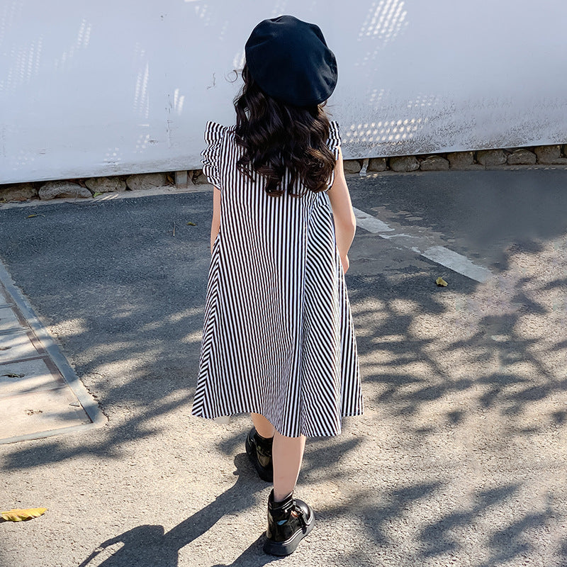 kid girl wearing a striped dress and black beret