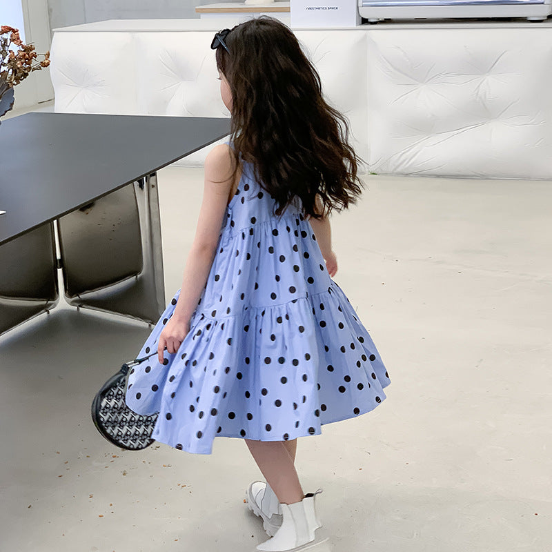 kid girl in blue dress with black polka dots