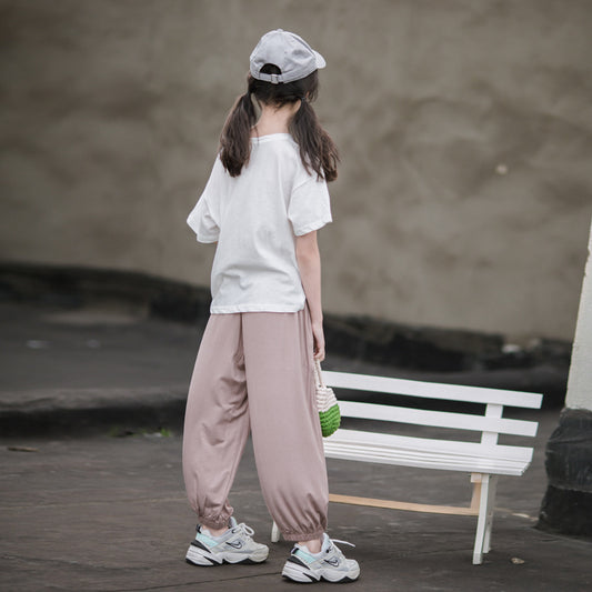 Child in casual white top wearing sneaker