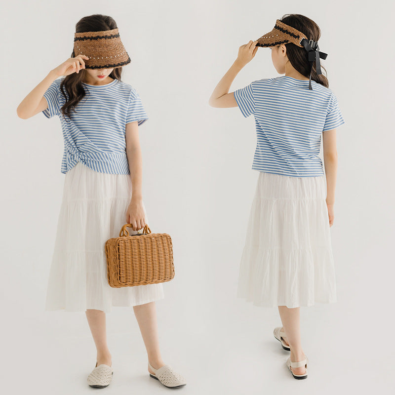 child in striped top and white tulle skirt