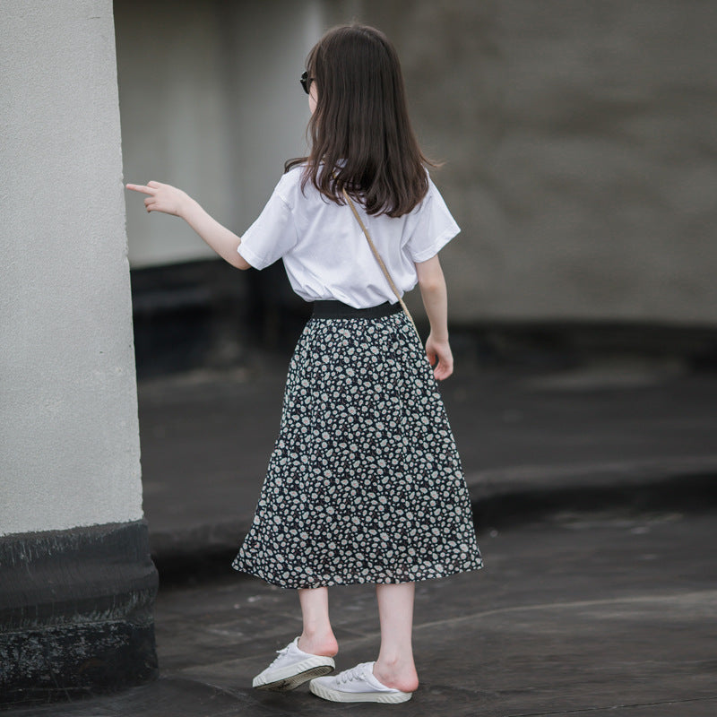 Child in a floral skirt and white top