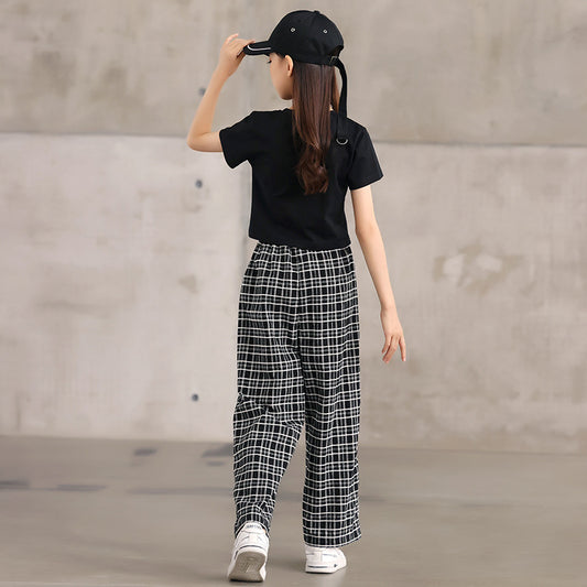 Child in black top and checkered pants